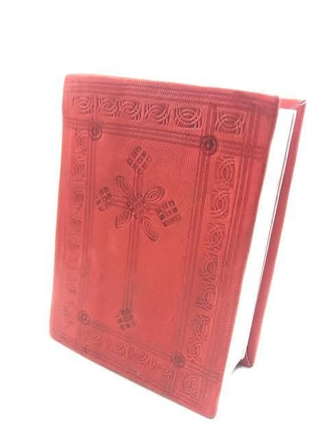 Hardcover Mezmur hymn book of traditional Ethiopian Orthodox hymns with notation.