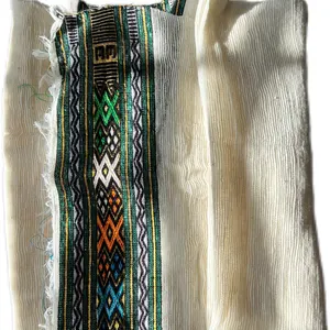 White hand-spun cotton Netela prayer shawl with a woven decorative border.
